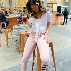 Pink distressed hem skinny jeans